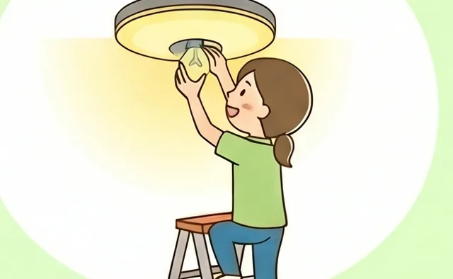 脚立に乗って照明の電球を交換する様子